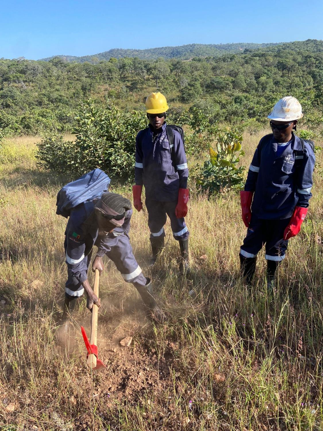 Soil sampling crew digging a sample pit